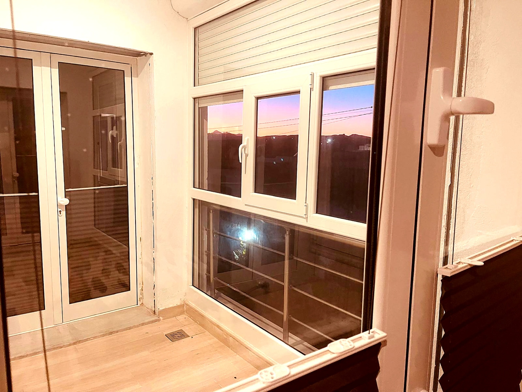 Glazed veranda at dusk with views over the countryside