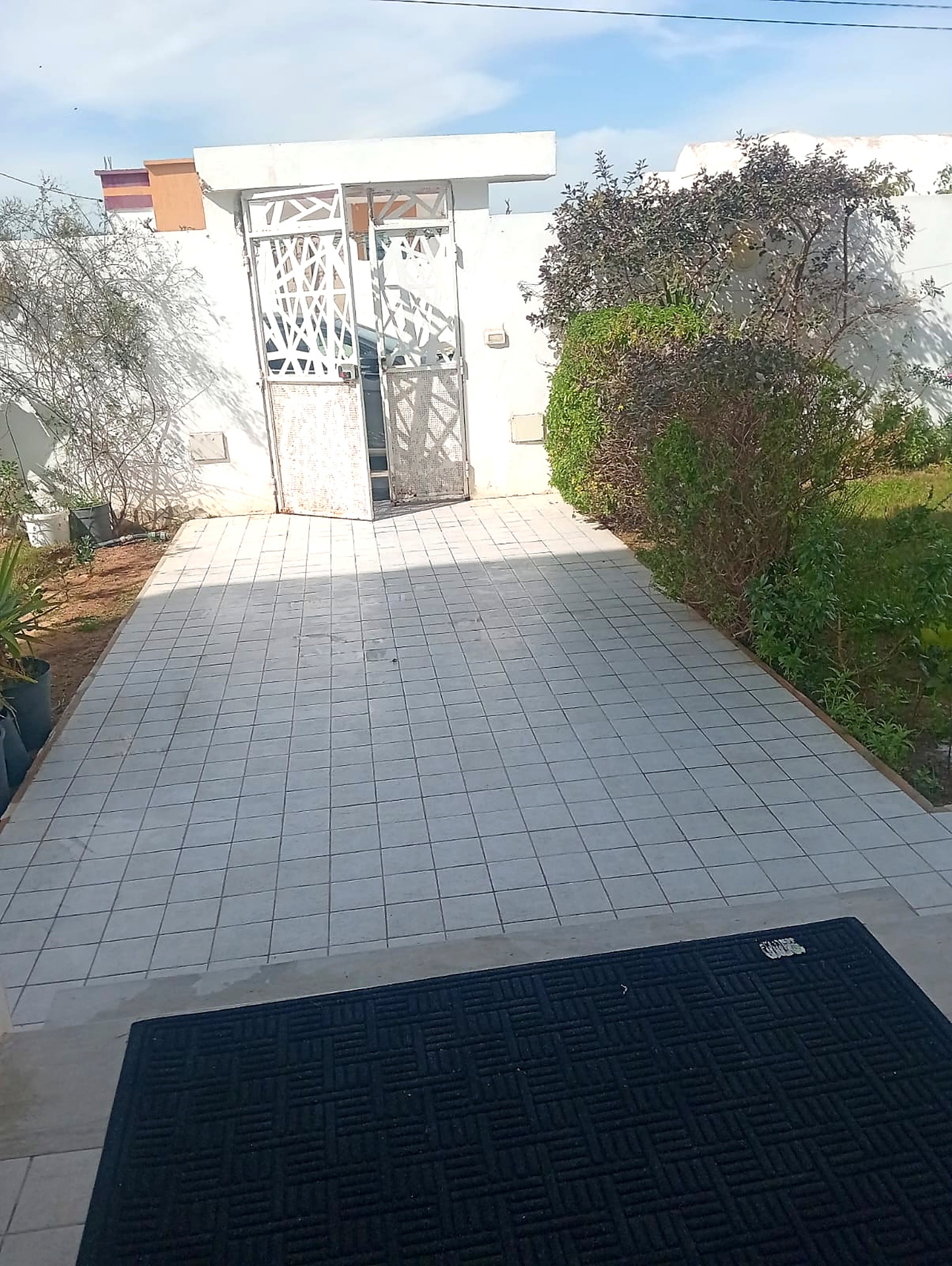 Private tiled driveway leading to the gated villa entrance