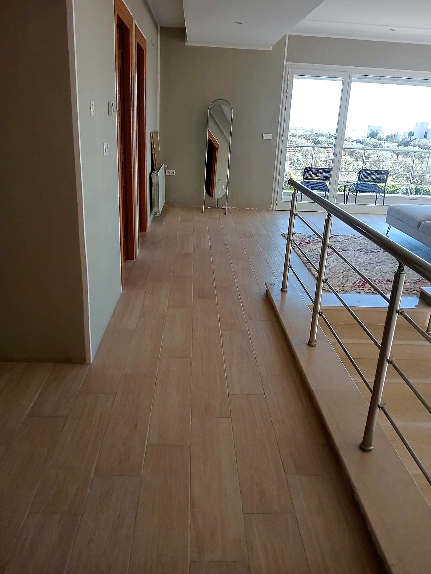 Upper floor landing in wood flooring leading to the bedrooms and sea view terrace