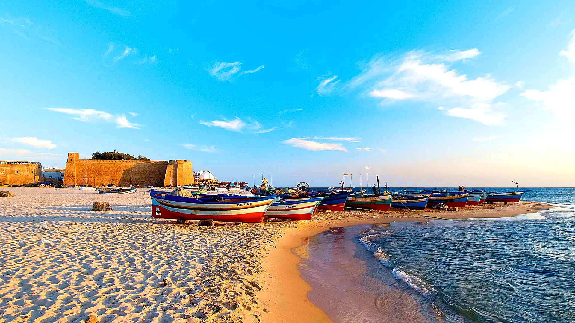 Colourful fishing boats beside the Hammamet kasbah
