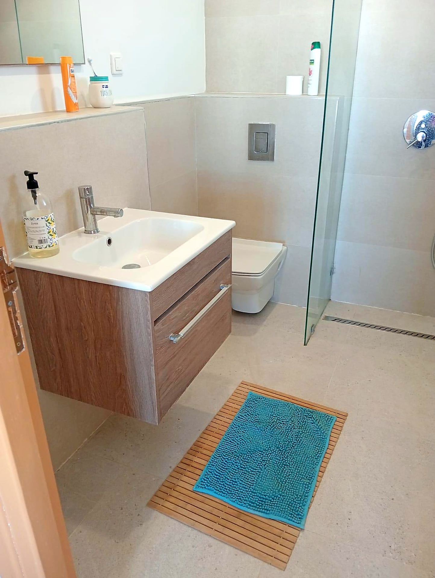Contemporary bathroom with floating oak vanity and walk-in shower