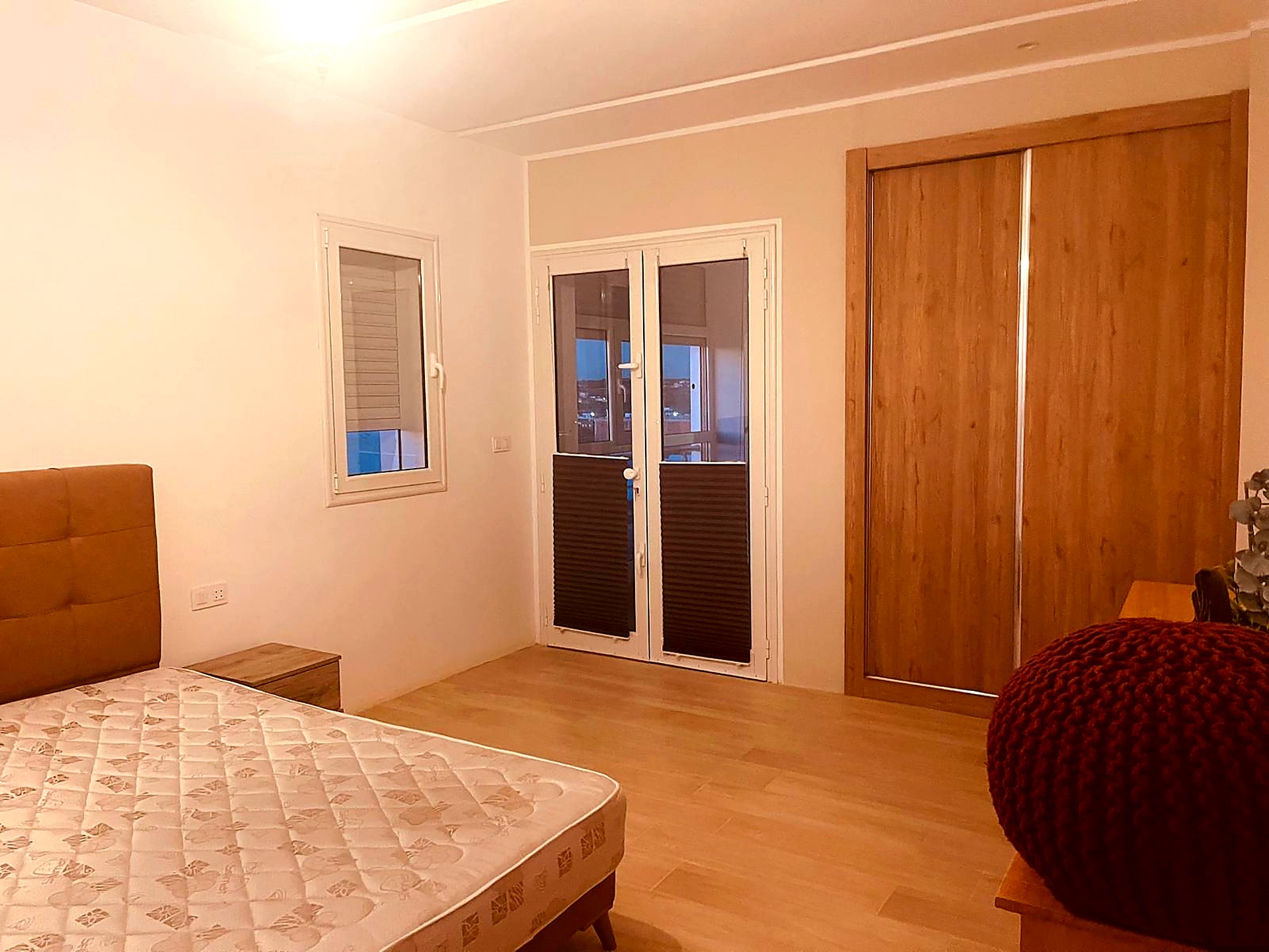 Guest bedroom with fitted oak wardrobe and private balcony doors