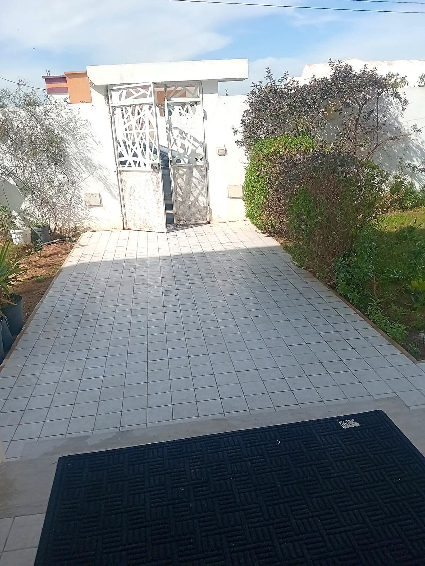 Private tiled driveway leading to the gated villa entrance